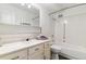 Bright bathroom with clean, neutral finishes, large mirror, and a bathtub with shower at 775 S Alton Way # 3C, Denver, CO 80247