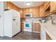 Well-equipped kitchen with white appliances and wooden cabinets for ample storage space at 775 S Alton Way # 3C, Denver, CO 80247
