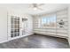 Bright living room space with built-in shelving, glass doors, and laminate wood flooring at 775 S Alton Way # 3C, Denver, CO 80247