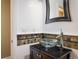 Stylish half bathroom with a vessel sink, modern fixtures, and decorative tile accents at 2976 Eagle Way, Boulder, CO 80301