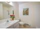 Bright bathroom with a single sink vanity, a toilet, and artwork hanging on the wall at 2976 Eagle Way, Boulder, CO 80301