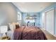 Cozy bedroom featuring soft blue walls, floating shelves, and a comfortable bed with a plum comforter at 2976 Eagle Way, Boulder, CO 80301