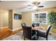 Eat-in kitchen area with a glass table and black chairs with natural light and hardwood flooring at 2976 Eagle Way, Boulder, CO 80301