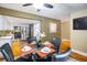 Dining room with hardwood floors, a glass-top table, and an open view into the modern kitchen at 2976 Eagle Way, Boulder, CO 80301