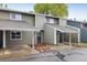 Two-story townhome showcasing a covered carport, grey siding and inviting front entrance with rock landscaping at 2976 Eagle Way, Boulder, CO 80301