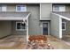 Exterior of the townhome with grey siding and a rock garden in front of the inviting front door at 2976 Eagle Way, Boulder, CO 80301