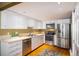 Well-lit kitchen with stainless steel appliances, light countertops, and hardwood floors with an area rug at 2976 Eagle Way, Boulder, CO 80301