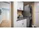 Convenient laundry area with stacked washer and dryer, storage cabinets, and a countertop at 2976 Eagle Way, Boulder, CO 80301
