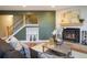 Comfortable living room with a cozy fireplace, hardwood floors, and a modern staircase at 2976 Eagle Way, Boulder, CO 80301