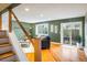 Bright living room featuring hardwood floors, modern staircase and sliding glass doors to the outside at 2976 Eagle Way, Boulder, CO 80301