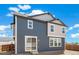 Rear exterior featuring a sliding glass door, backyard with a wood fence, and a two-tone color palette at 2237 Garden Ave, Brighton, CO 80601