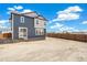 Large backyard space with wood fencing around the perimeter and an installed sliding glass door at 2237 Garden Ave, Brighton, CO 80601
