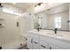 Modern bathroom featuring a glass enclosed shower and double sink vanity with sleek, dark fixtures at 2237 Garden Ave, Brighton, CO 80601