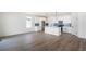 Open concept kitchen featuring white cabinets, modern stainless steel appliances, and a center island with pendant lighting at 2237 Garden Ave, Brighton, CO 80601