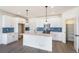 Beautiful kitchen with white cabinets, stainless steel appliances, quartz countertops, and a large island at 2237 Garden Ave, Brighton, CO 80601