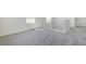 Landing area features neutral carpet, white walls, a window, and a staircase with white railing at 2237 Garden Ave, Brighton, CO 80601