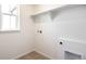 Convenient laundry room features built-in shelving, washer/dryer hookups, and wood-look flooring at 2237 Garden Ave, Brighton, CO 80601