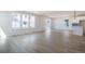 Sunlit living room with wood-look flooring and large windows, creating a bright and airy ambiance at 2237 Garden Ave, Brighton, CO 80601