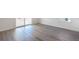 Bright living room with light wood floors and large sliding glass door to backyard at 2237 Garden Ave, Brighton, CO 80601