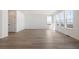 Expansive living area with wood-look flooring and multiple windows, offering abundant natural light and space at 2237 Garden Ave, Brighton, CO 80601