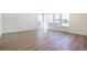 Bright, sunlit living room featuring beautiful wood-look flooring and ample windows for natural light at 2237 Garden Ave, Brighton, CO 80601