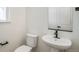 Powder room with modern fixtures, pedestal sink, and a sleek black faucet at 2237 Garden Ave, Brighton, CO 80601