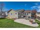 An inviting backyard offers a patio area perfect for outdoor dining and entertaining on a well-maintained lawn at 11462 Iola St, Commerce City, CO 80640