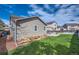 Spacious backyard featuring a lush lawn, and a patio with outdoor furniture for entertaining at 11462 Iola St, Commerce City, CO 80640