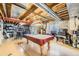 Unfinished basement featuring a pool table, exposed ceiling, and concrete walls at 11462 Iola St, Commerce City, CO 80640