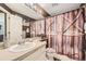 The bathroom has a sink, and a shower with barn-style curtains at 11462 Iola St, Commerce City, CO 80640