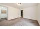 A neutral bedroom with a doorway to another room; ideal for a home office or guest suite at 11462 Iola St, Commerce City, CO 80640