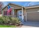 Charming home with a tidy front yard, American flag, and inviting brick accents at 11462 Iola St, Commerce City, CO 80640