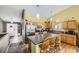 Bright kitchen featuring wood cabinets, stainless steel appliances, and a functional kitchen island at 11462 Iola St, Commerce City, CO 80640