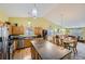 Open concept kitchen with a large island and stylish pendant lighting, open to the dining and living room at 11462 Iola St, Commerce City, CO 80640