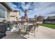 Outdoor patio space including a barbecue grill, table, chairs, and fenced backyard at 11462 Iola St, Commerce City, CO 80640