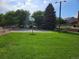 Community basketball court surrounded by mature landscaping with seating and picnic tables at 3300 W Florida Ave # 36, Denver, CO 80219