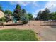 Community playground area with slide and play equipment and fence around the outside at 3300 W Florida Ave # 36, Denver, CO 80219