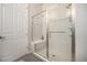 Modern bathroom featuring a glass-enclosed shower with a built-in bench seat at 811 W 128Th Pl, Westminster, CO 80234