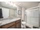 Bathroom featuring granite counters, tile flooring, and a glass enclosed walk-in shower at 811 W 128Th Pl, Westminster, CO 80234