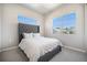 Bedroom with neutral tones, large windows, and comfortable gray headboard at 811 W 128Th Pl, Westminster, CO 80234