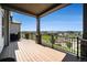 Covered deck featuring wood flooring, brick supports, and metal railing with views of the community at 811 W 128Th Pl, Westminster, CO 80234