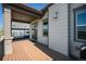 Covered deck featuring wood flooring and views of the exterior of the home at 811 W 128Th Pl, Westminster, CO 80234