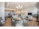 Cozy dining area seamlessly connected to the modern kitchen and living space with bright light fixtures at 811 W 128Th Pl, Westminster, CO 80234