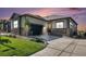 Beautiful home featuring a gray exterior, stone accents, a two-car garage, and a lush lawn at 811 W 128Th Pl, Westminster, CO 80234
