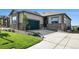 Charming home featuring stone accents, a well-manicured lawn, and a driveway leading to an attached two-car garage at 811 W 128Th Pl, Westminster, CO 80234
