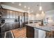 Well-equipped kitchen featuring stainless steel appliances, granite countertops, and stylish wood flooring at 811 W 128Th Pl, Westminster, CO 80234