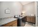 Convenient laundry room with granite countertops and modern appliances at 811 W 128Th Pl, Westminster, CO 80234