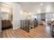 Open living area features hardwood floors, fireplace, and flows into powder room at 811 W 128Th Pl, Westminster, CO 80234