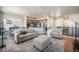 Spacious living room with hardwood floors, neutral tones, and an open layout connecting to the kitchen at 811 W 128Th Pl, Westminster, CO 80234