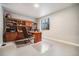Home office with an oversized desk and an entire wall of built-in bookshelves and storage cabinets at 811 W 128Th Pl, Westminster, CO 80234